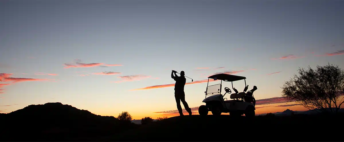 A man playing golf. Pain and injuries from gold can be managed with a luxury massage chair