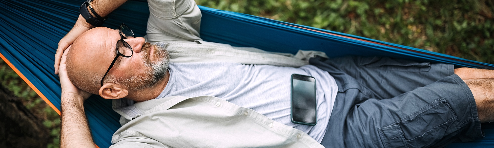 man relaxing in hammock as a self-care practice