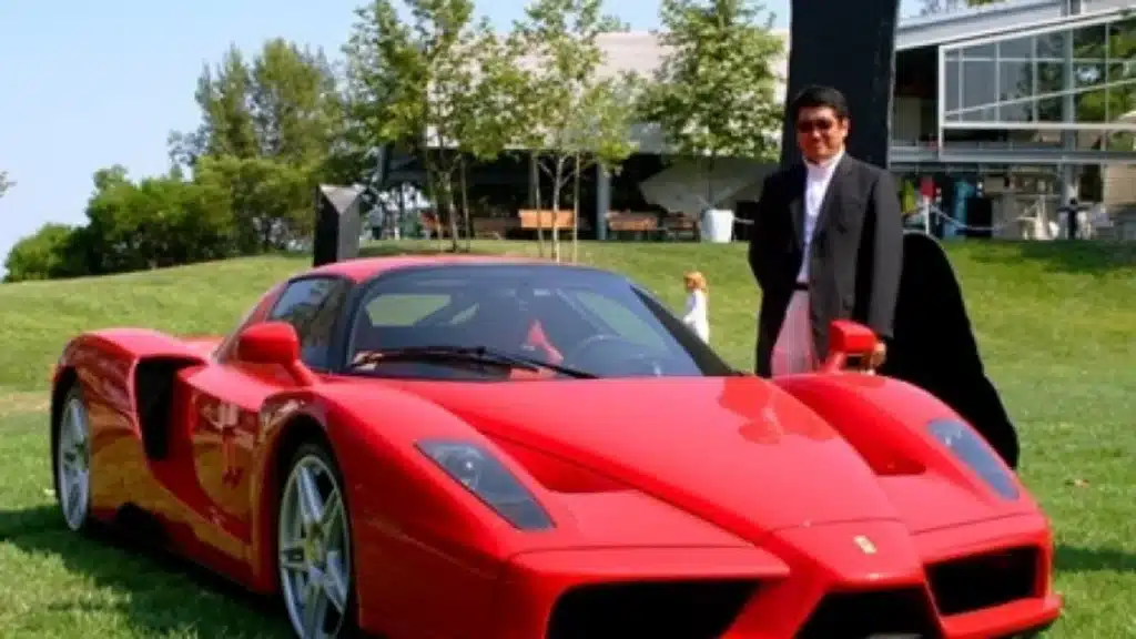 OHCO luxury massage chair designer pictured with one of his most famous designs, the Ferrari Enzo